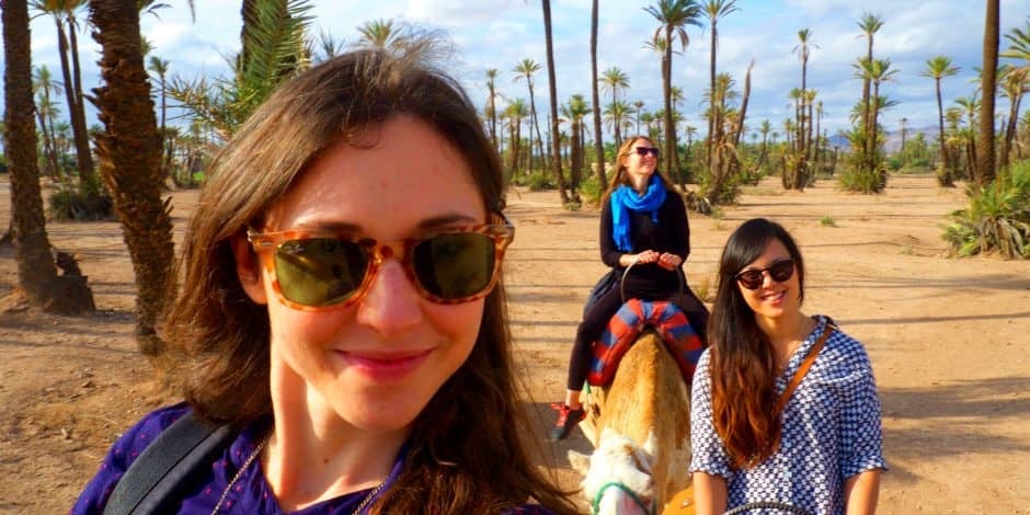 women riding camels in marrakech