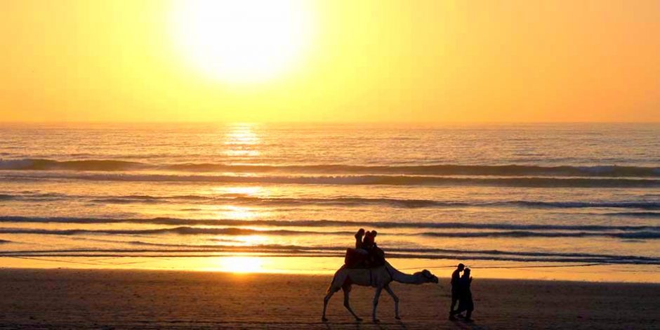 camel riding in moroccan beach