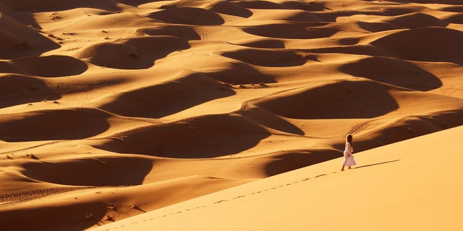 woman walking alone in desert