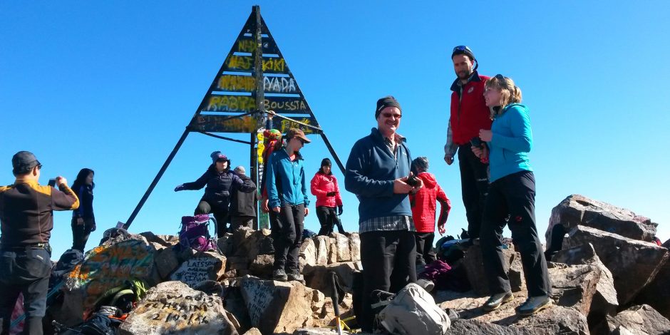 tourists in toubkal mount summit