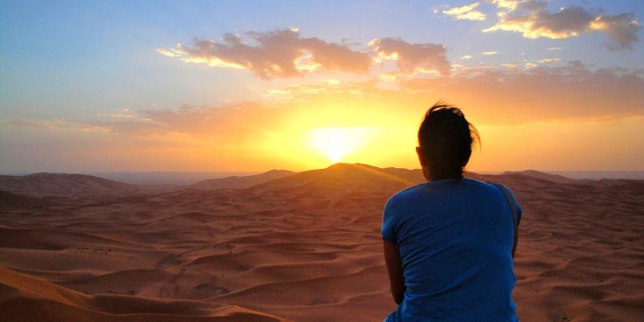 woman enjoying sunset in the desert
