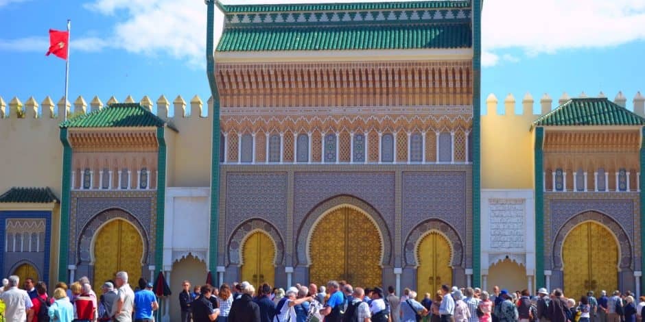 group of tourists in front of place gate in fes