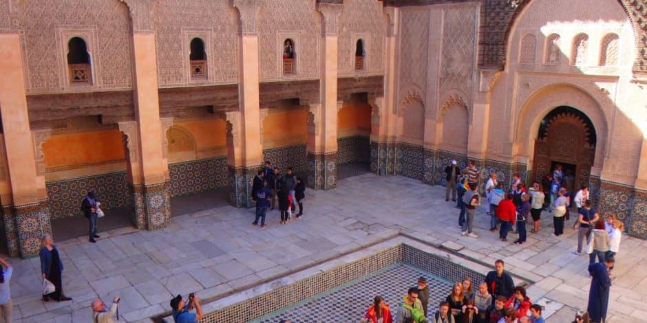 tourists inside ben youssef coranic school in marrakech