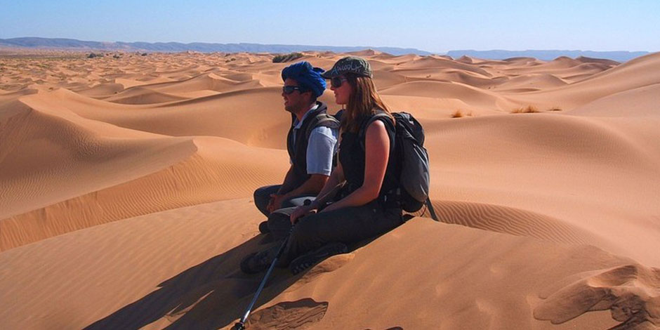 couple enjoying moroccan sahara desert