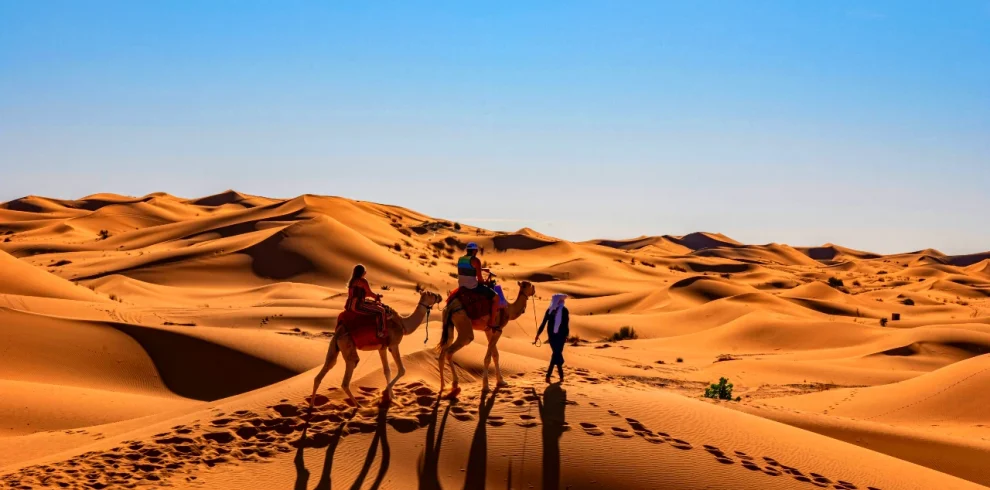 couple riding camel in Morocco Sahara