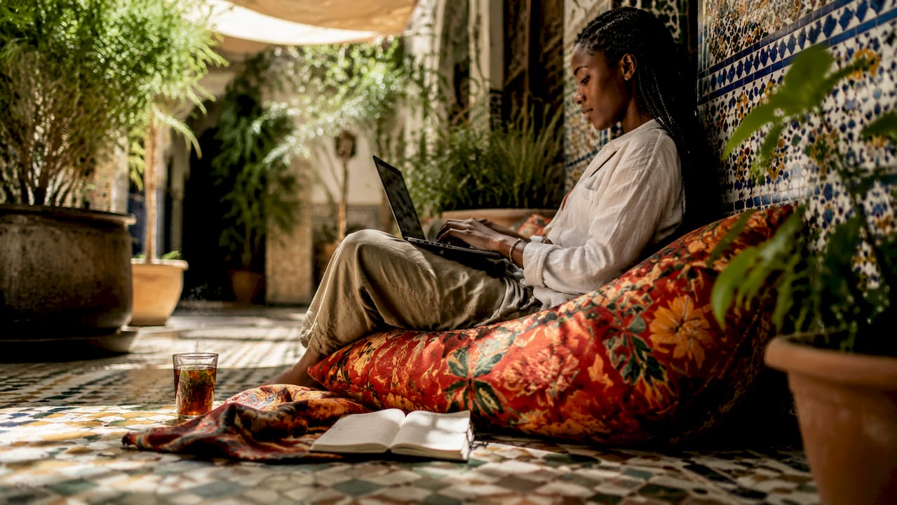 Digital nomad working in a Moroccan café courtyard