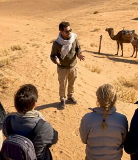 Travel guide explaining Sahara desert tour
